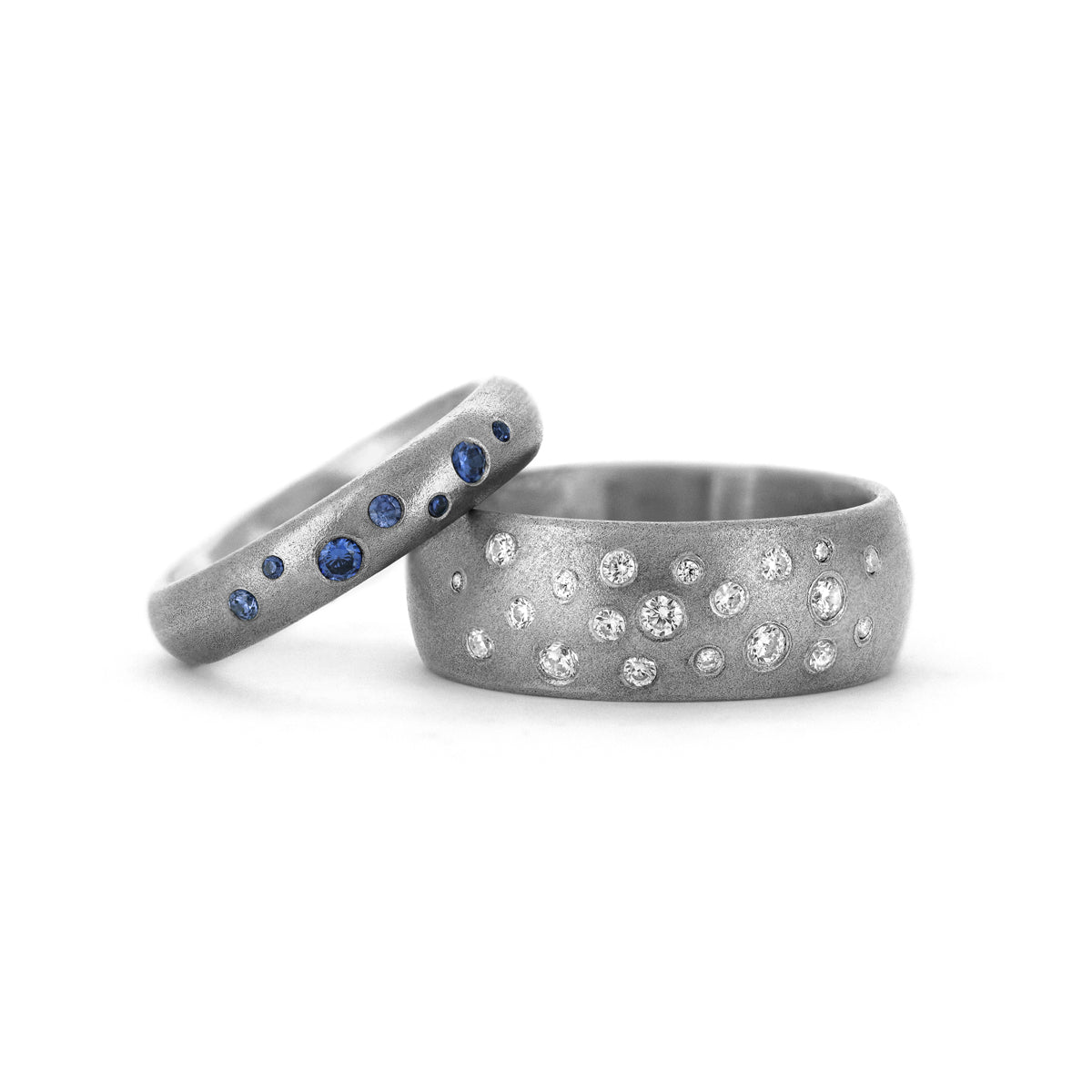 Wedding rings flush set with diamonds and sapphires