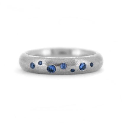 Wedding ring flush set with sapphires recycled white gold sapphire wedding band