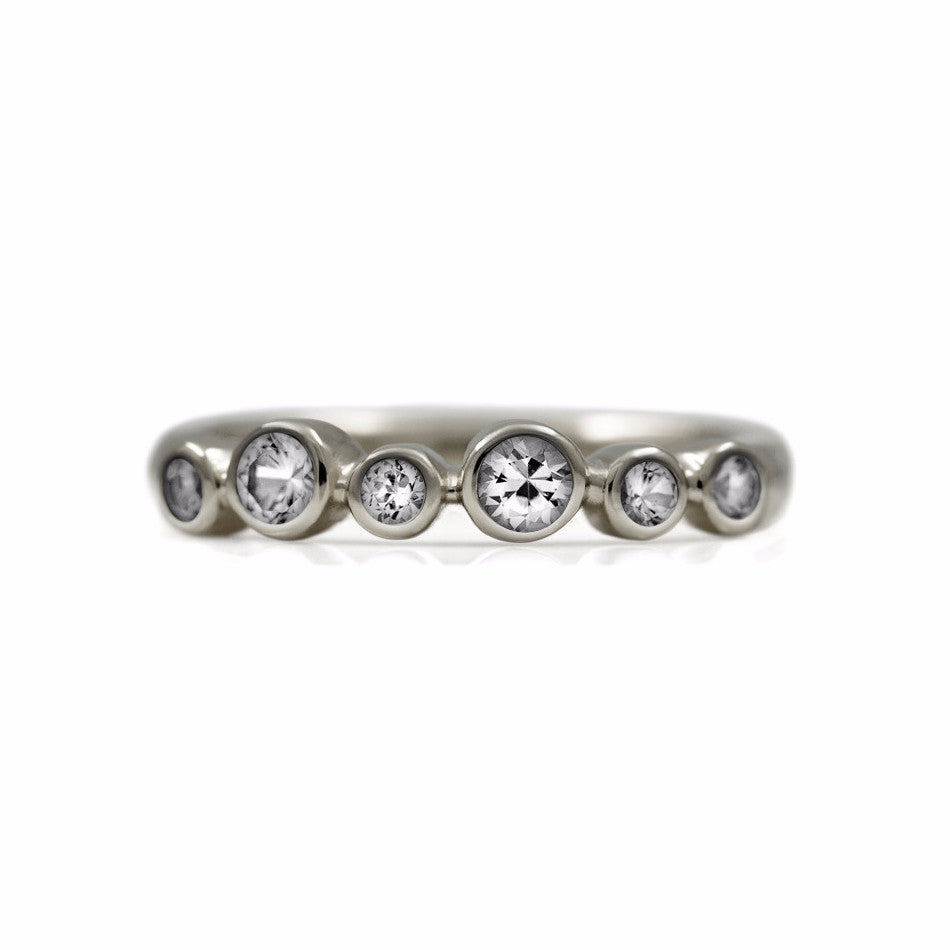 Halo half eternity ring - 9ct white gold and white topaz